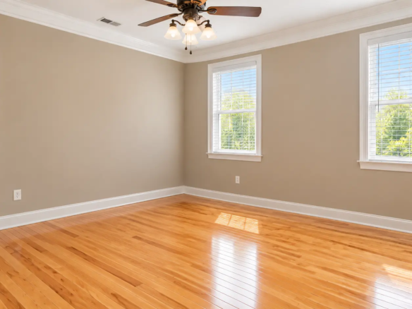 Private office with gray walls, crown molding and two windows at EOS in Bogart GA