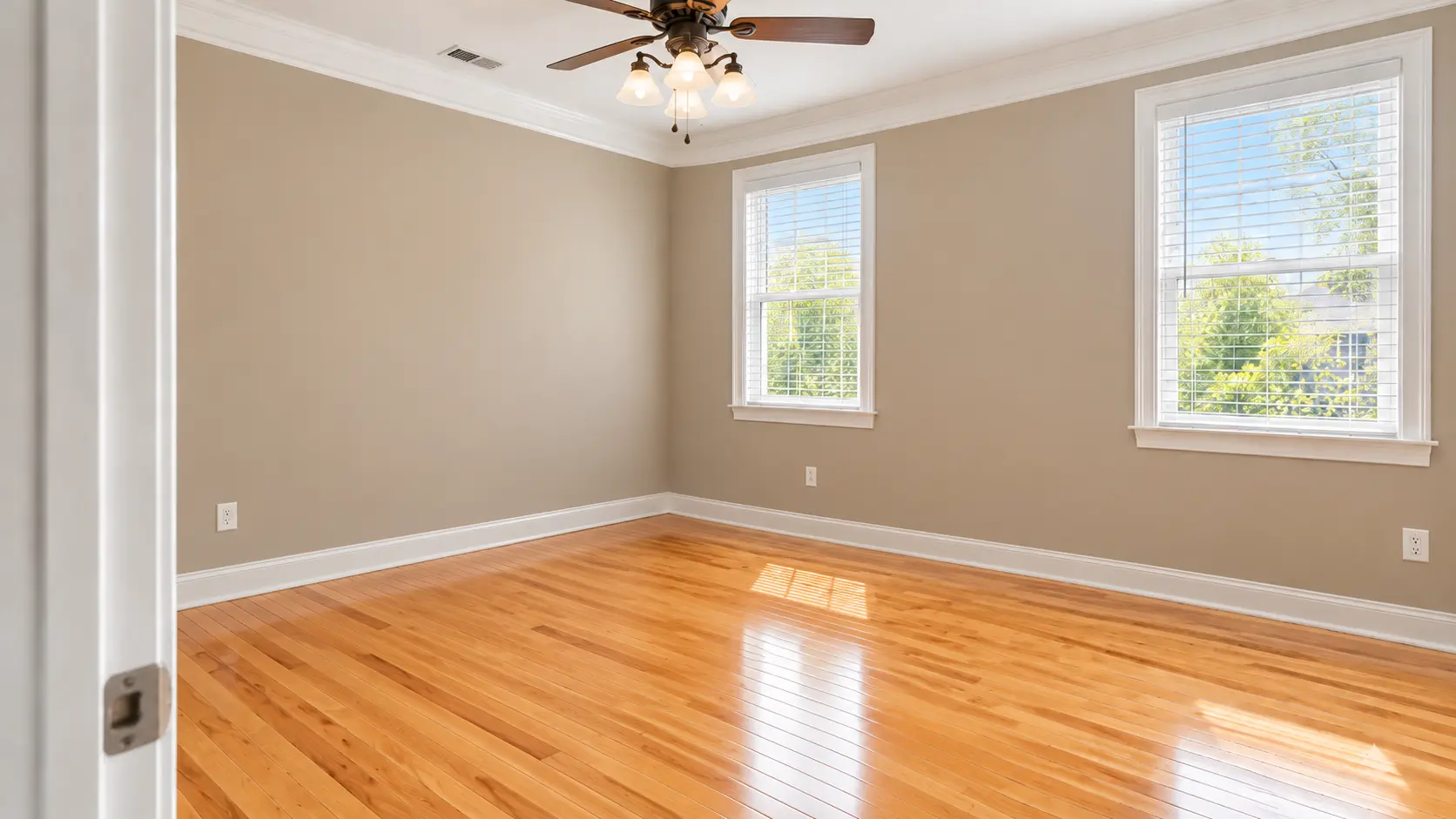 Bright Office with Natural Light Private office with gray walls, crown molding and two windows at EOS in Bogart GA