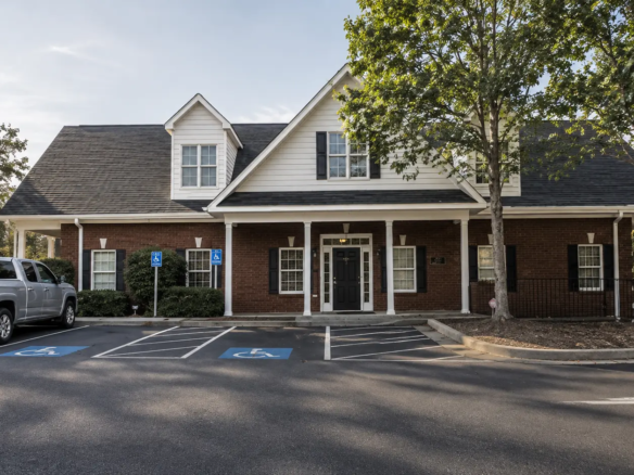 Exterior front view of two-story brick building housing 1020 Suite 321 at EOS Offices in Bogart Georgia.
