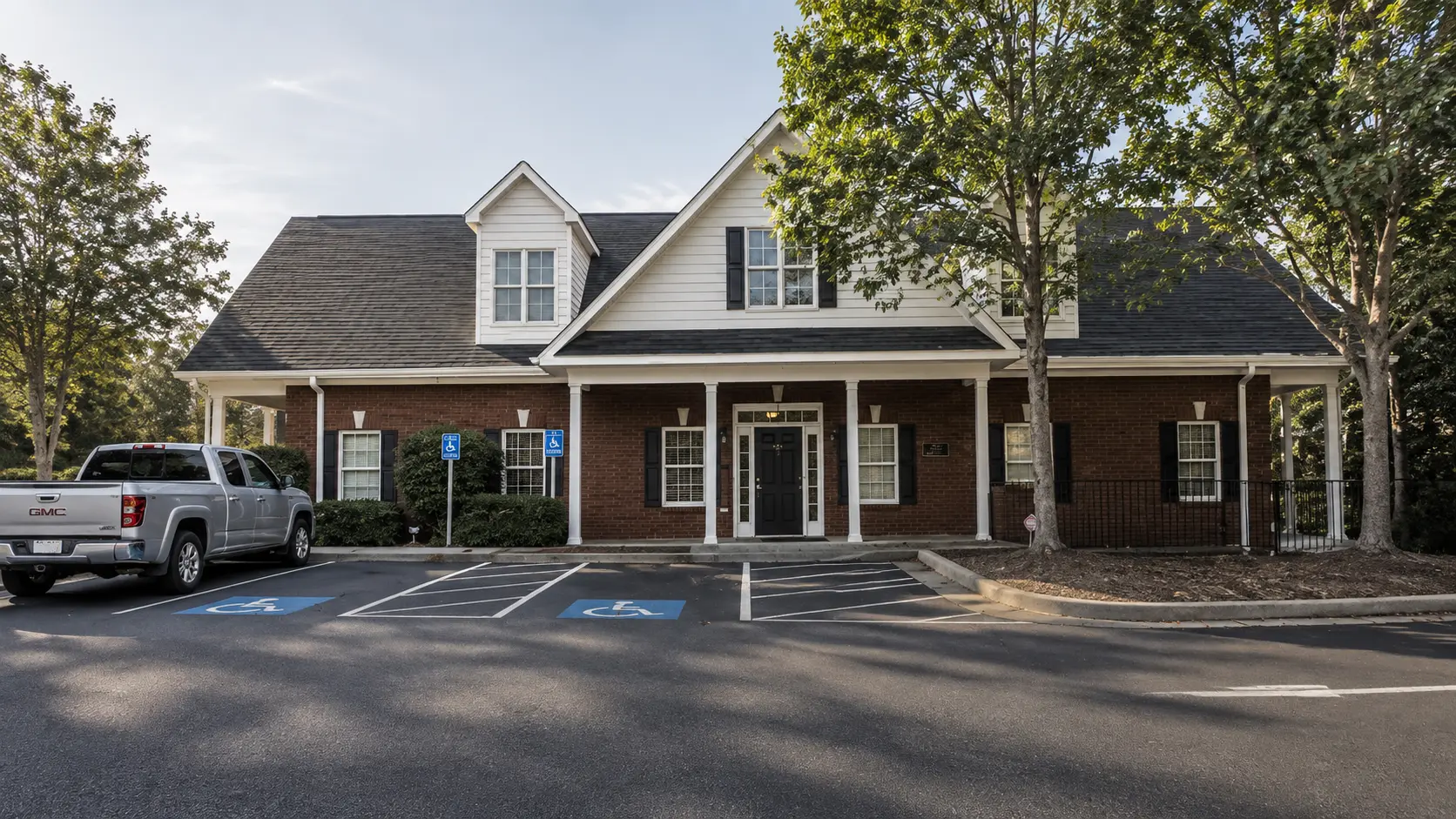 Exterior front view of two-story brick building housing 1020 Suite 321 at EOS Offices in Bogart Georgia.